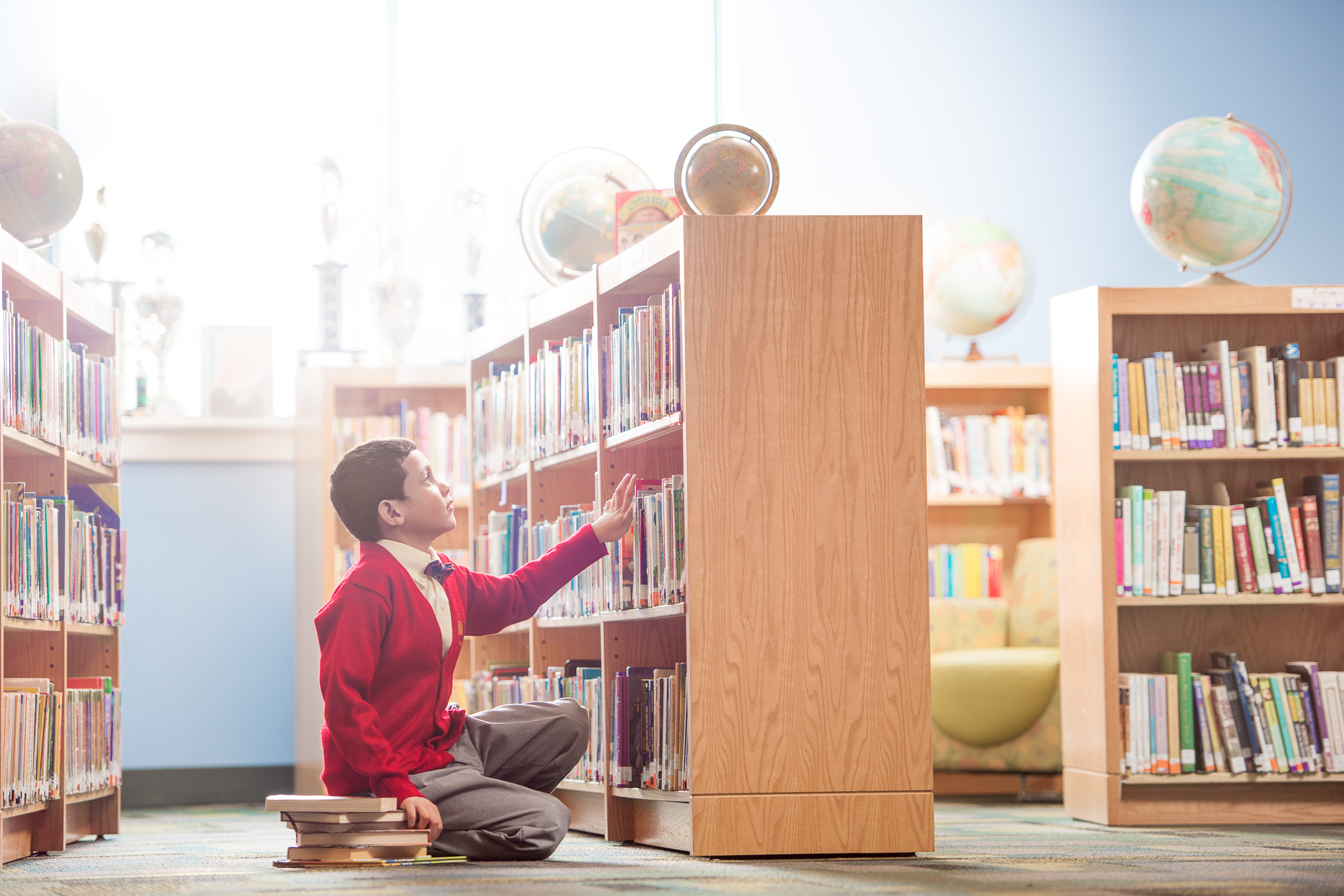 Library Boy looks for books | GLA Philadelphia Photographer