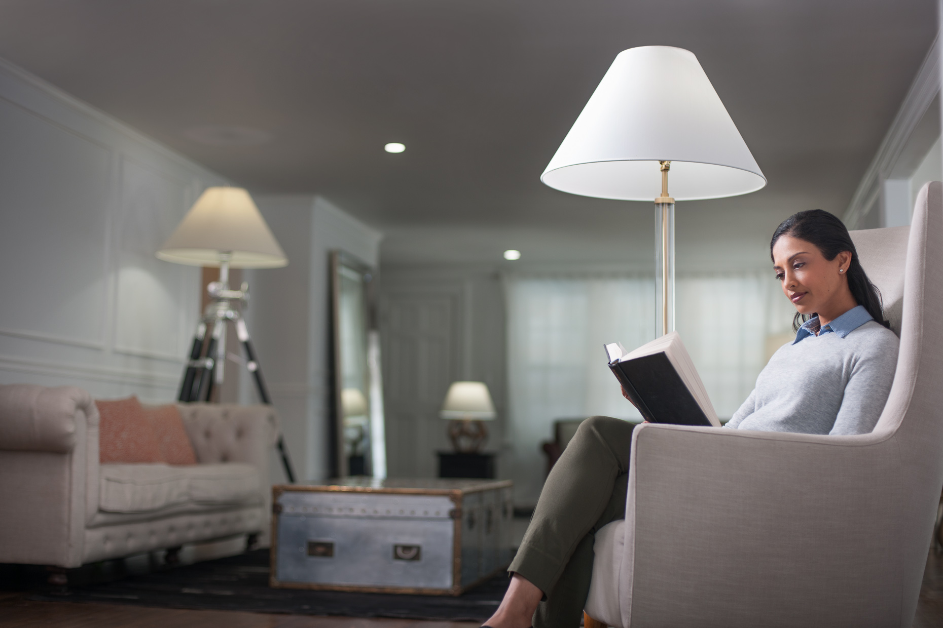 Woman reading in living room | Philips LED Commercial