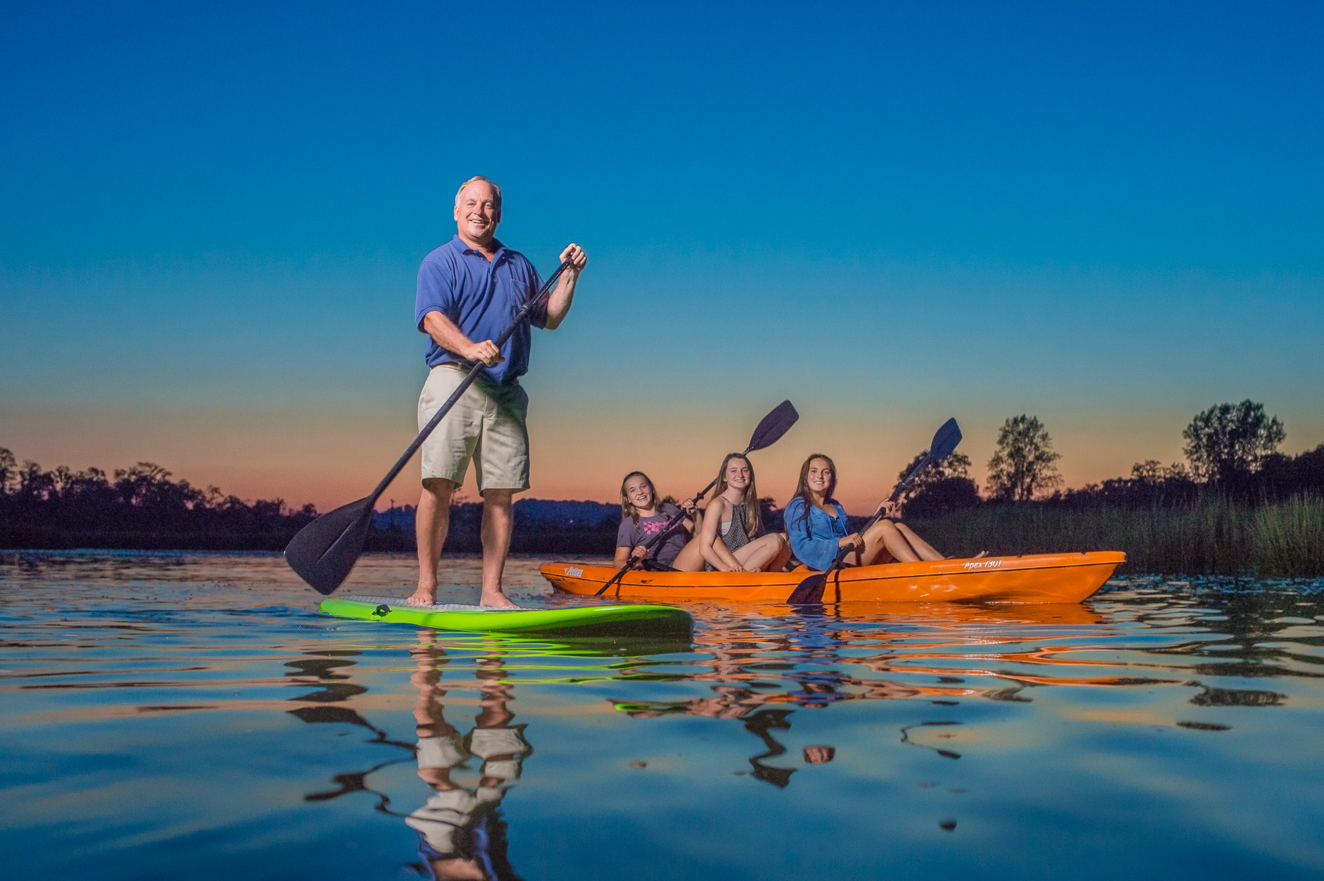 Doug Borden and daughters on boat paddle board | Veridian